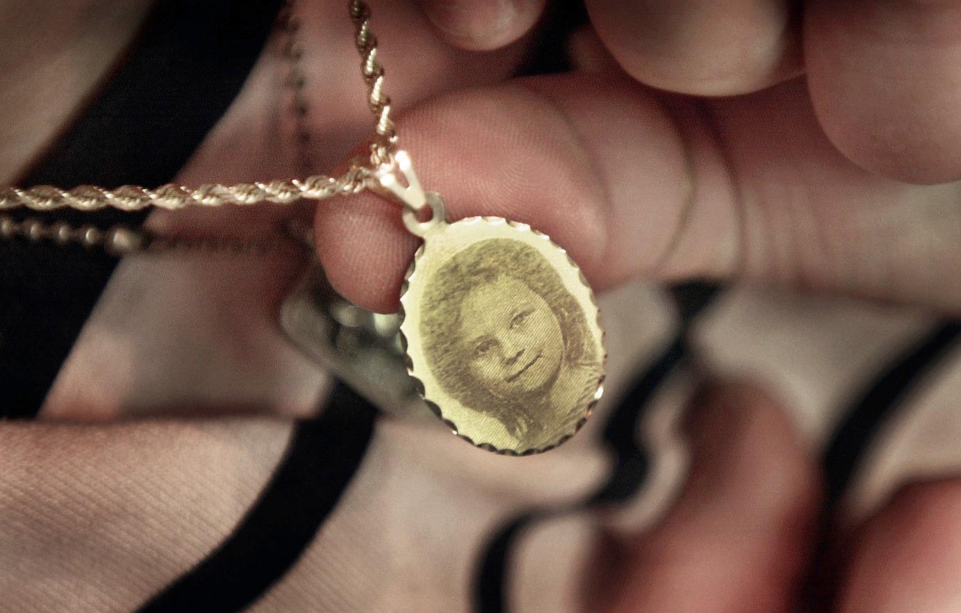 A locket with an engraving of her daughter Kayla hangs around the neck of Veronica McQueen on Feb. 12, 2001. (Flint Journal File Photo by Steve Jessmore)