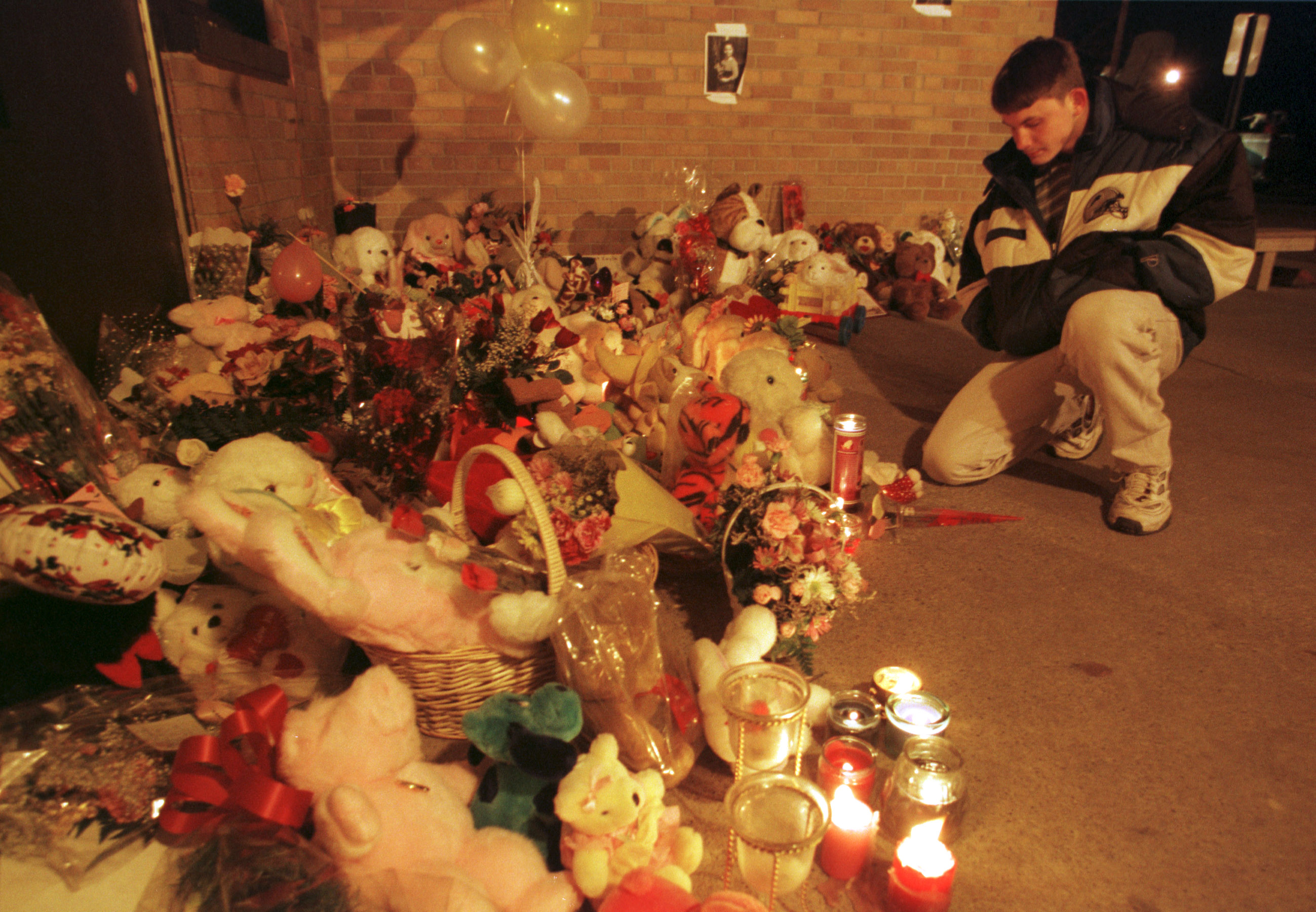 Raymond Fitch, 18, keeps vigil at the front entrance to Buell Elementary School in Mt. Morris Township near Flint Wednesday night, Mar. 1, 2000. Kayla Rolland, 6, was fatally shot by a six-year-old classmate. Fitch's sister was Rolland's best friend. (Flint Journal File Photo by Al Goldis)
