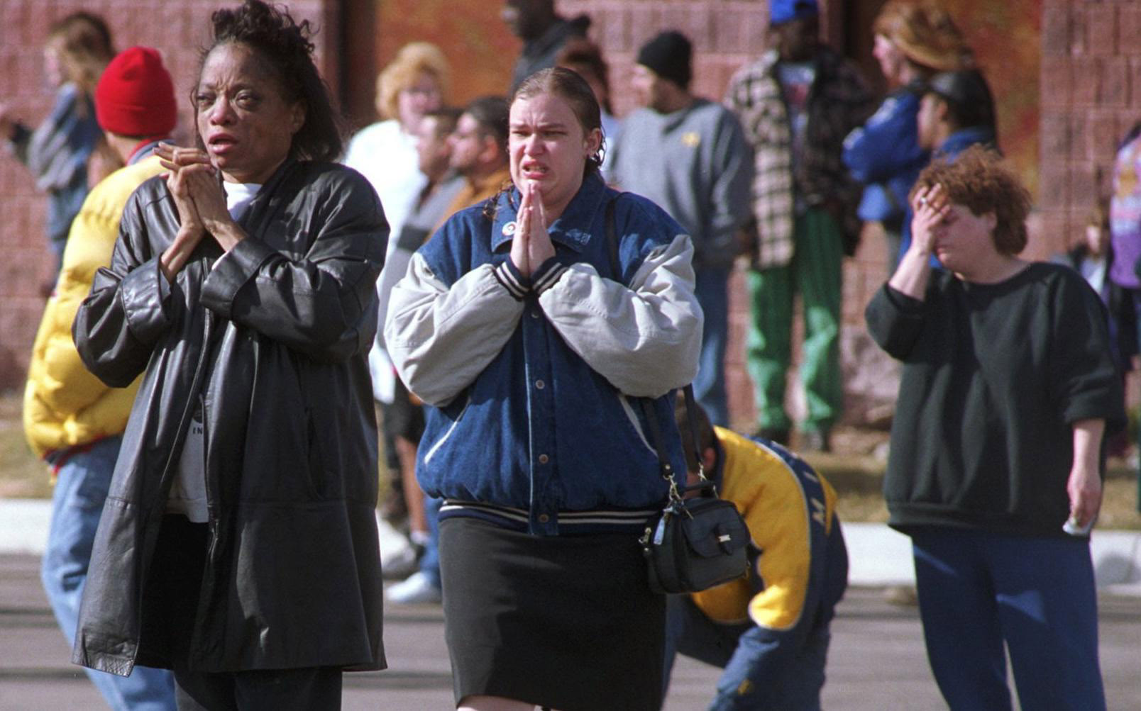 Family and friends of Buell Elementary School students in Michigan wait to be reunited on Feb. 29, 2000. Most of the students were put on buses and taken to a church across the street. Buell was the site of a shooting that killed first-grader Kayla Rolland that day. (Flint Journal File Photo by Jane Hale)