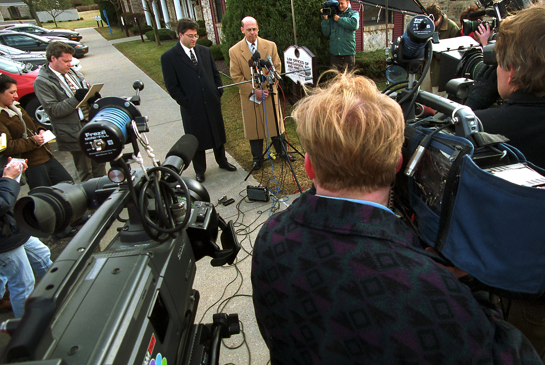 Attorney J. Dallas Winegarden, Jr., (center, at microphone) was retained by Kayla Rolland's mother Veronica McQueen. Here he holds press conference outside his office on Thursday, March 3, 2000. Kayla, a first grader at Buell Elementary School in Mt. Morris Township, was shot and killed by another first grader at the school on Tuesday, February 29, 2000. Also representing with Winegarden will be attorney Jeffrey J. Himelhoch, standing at Winegarden's right. (Flint Journal File Photo by Steve Jessmore)