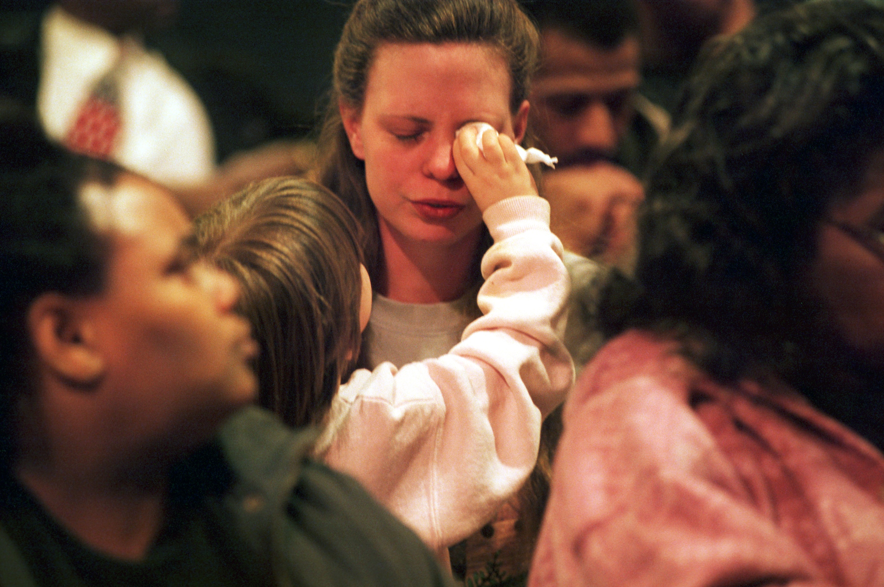 Cheyenne Fox, 4, wipes the tears away from her mother's eyes during an emotional school board meeting at Dailey Elementary School on March 1, 2000. "Something's got to be done," said Cheyenne's mom Iva Flanagan. The school board meeting was held the day after Kayla Rolland, 6, was shot by a first grade classmate at Buell Elementary School. The meeting's regular agenda was set aside to discuss school violence and let parents air their concerns. (Flint Journal File Photo by Melissa Lyttle)