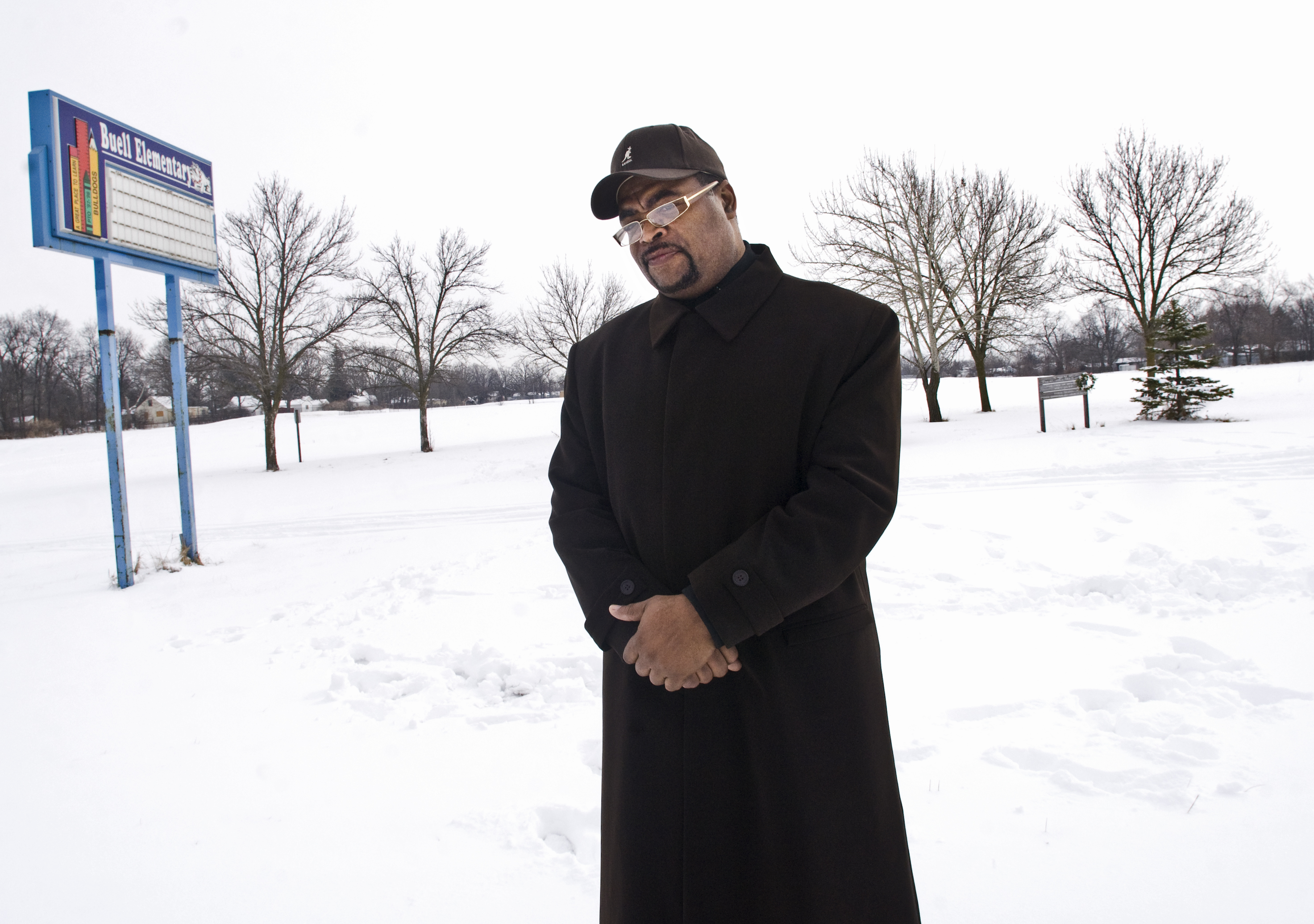 "It doesn't negate the fact that it happened. You look across here and you see what was and that doesn't take away from the moment. It's still there," said Rev B.J. Harvey of Greater Friendship Azusa Church of God in Christ, about the empty field that was the location of Buell Elementary School where the Kayla Rolland shooting occurred ten years ago. "It's not going to erase it." (Flint Journal File Photo by Ryan Garza)