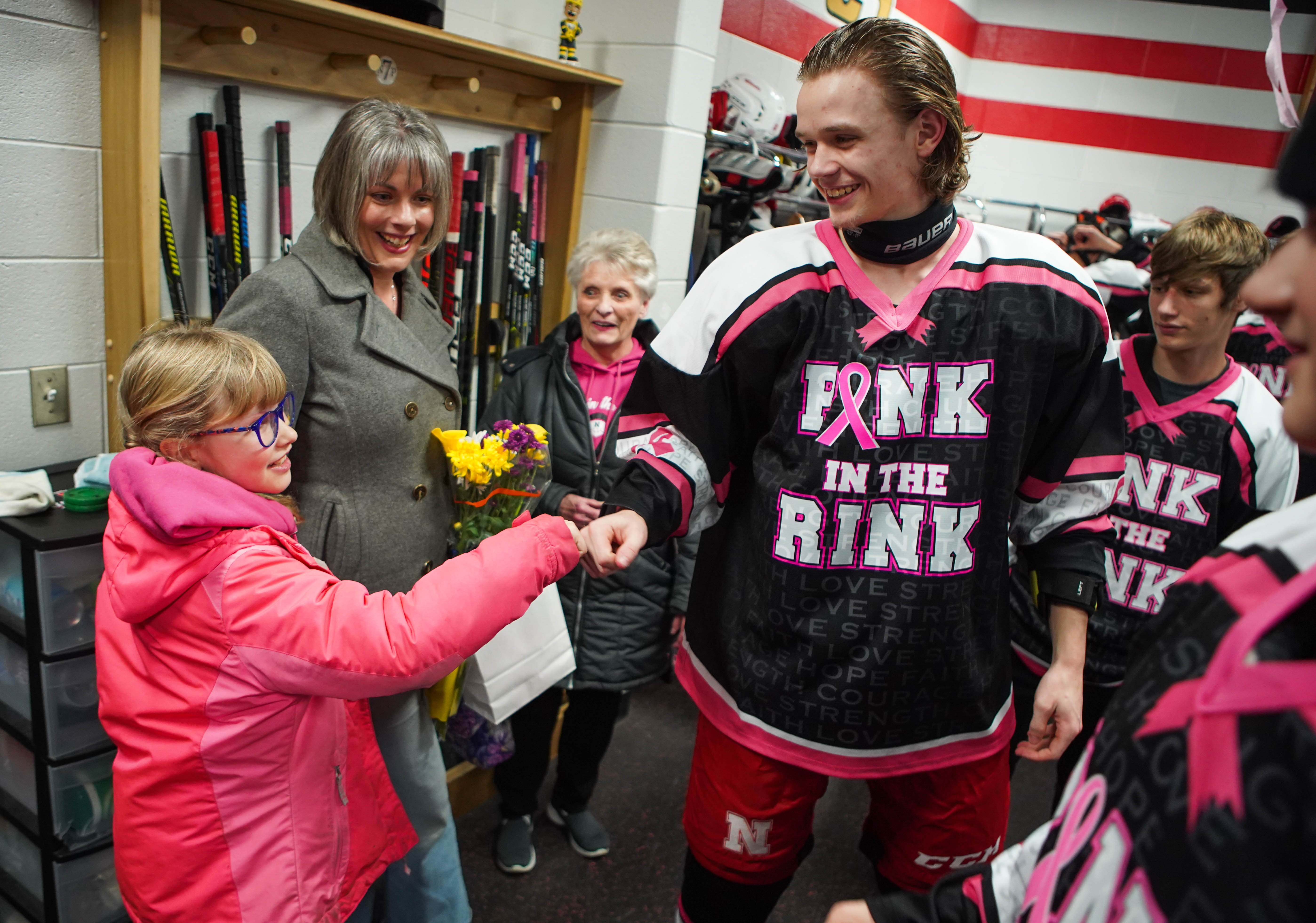 Hockey players honor cancer victims with special pink jerseys